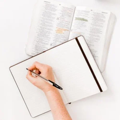 bible with hand writing in notebook